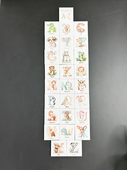 Sheet of alphabet stickers with animal illustrations on a dark background